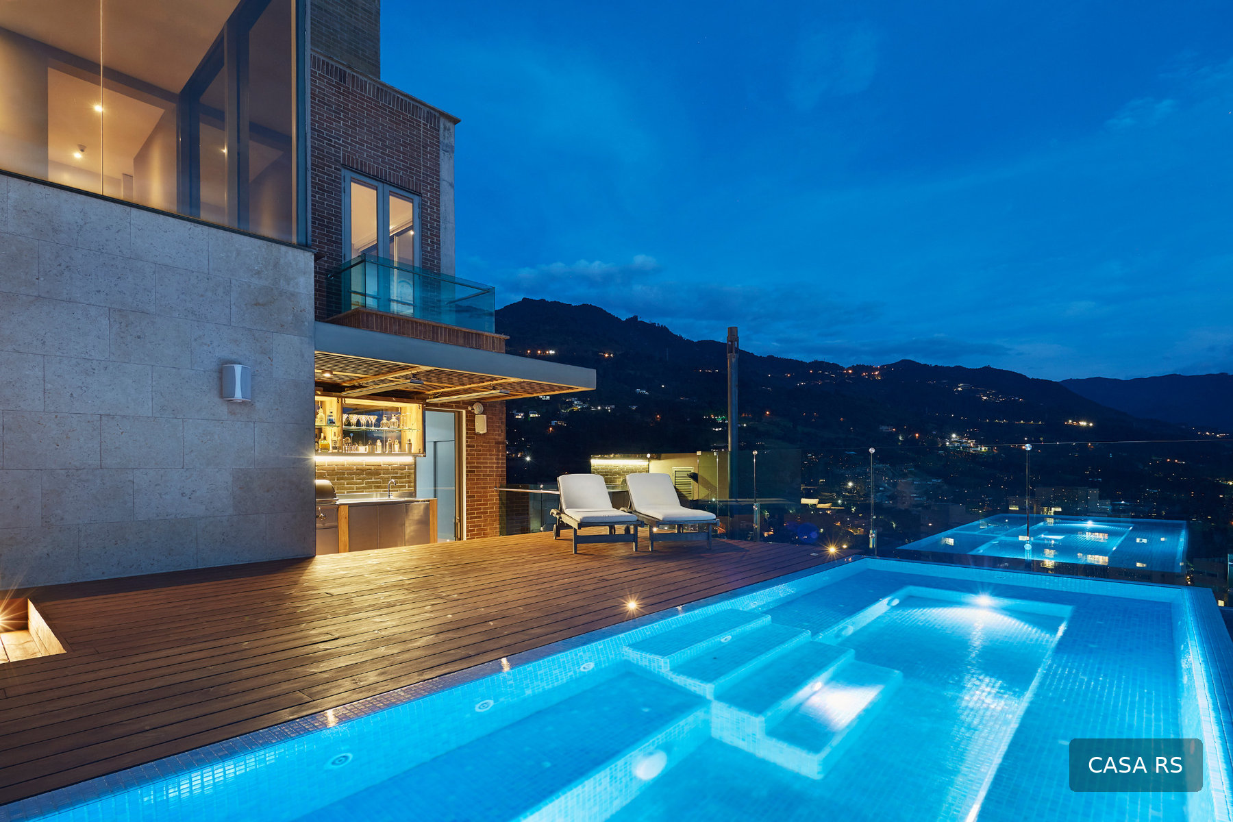 Casa RS illuminated rooftop pool at dusk