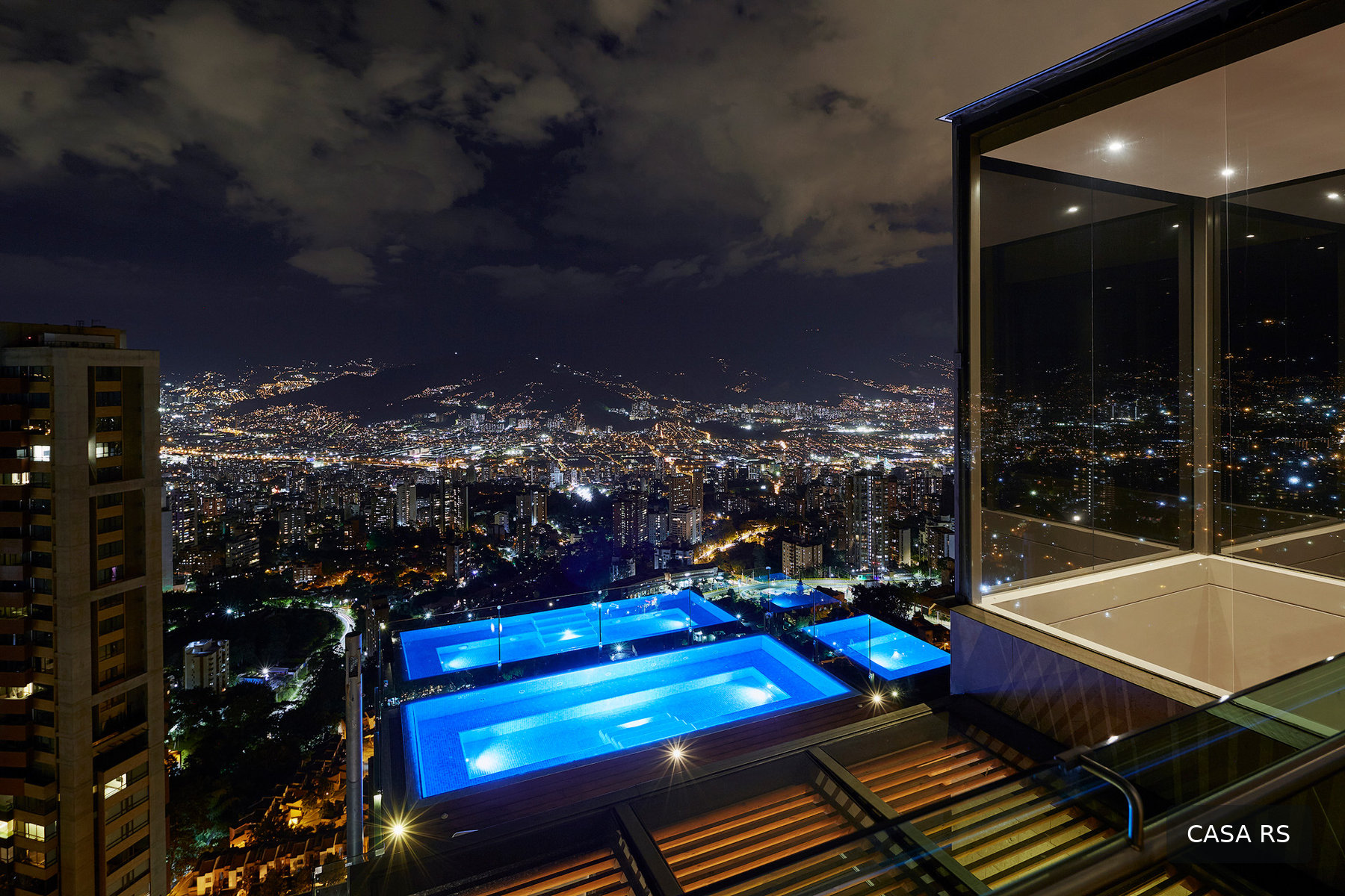 Casa RS city lights and rooftop pool at night